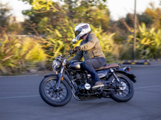 Honda GB350 action riding around a corner in the sun