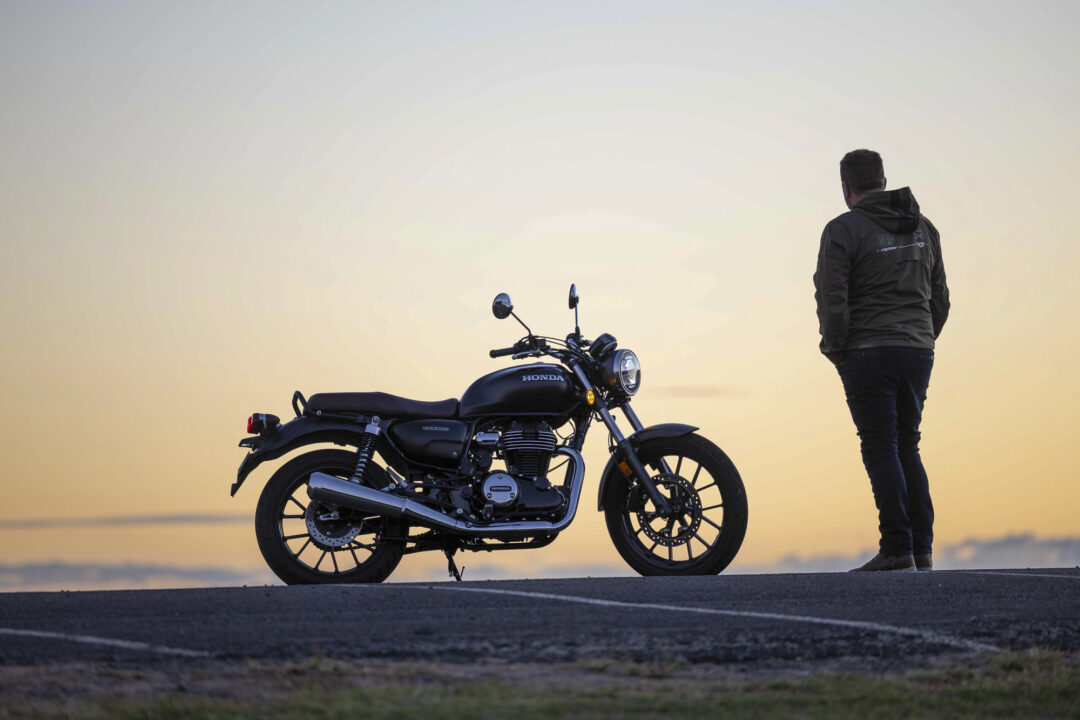 Honda GB350 parked at sunset with rider wearing Ixon jacket and casual motorcycle clothing