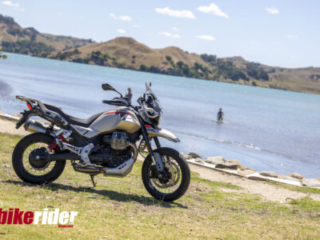 Moto Guzzi V85 TT Travel parked next to lake