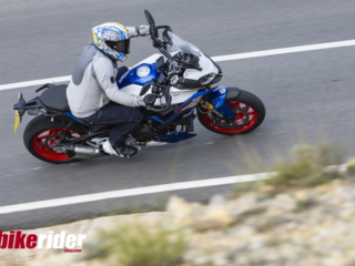 BMW F900XR 2025 touring motorcycle carving through a twisty mountain pass