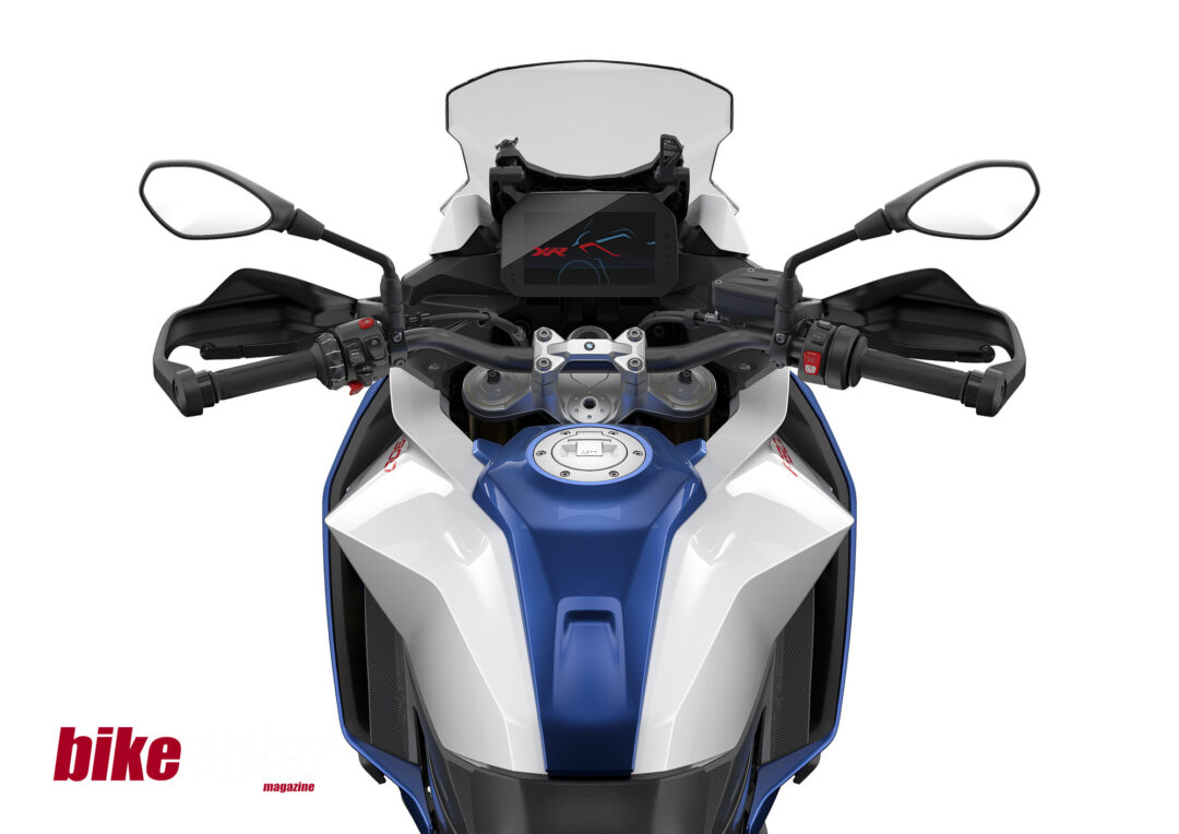 Close-up of BMW F900XR TFT display showing navigation wheel and riding modes.