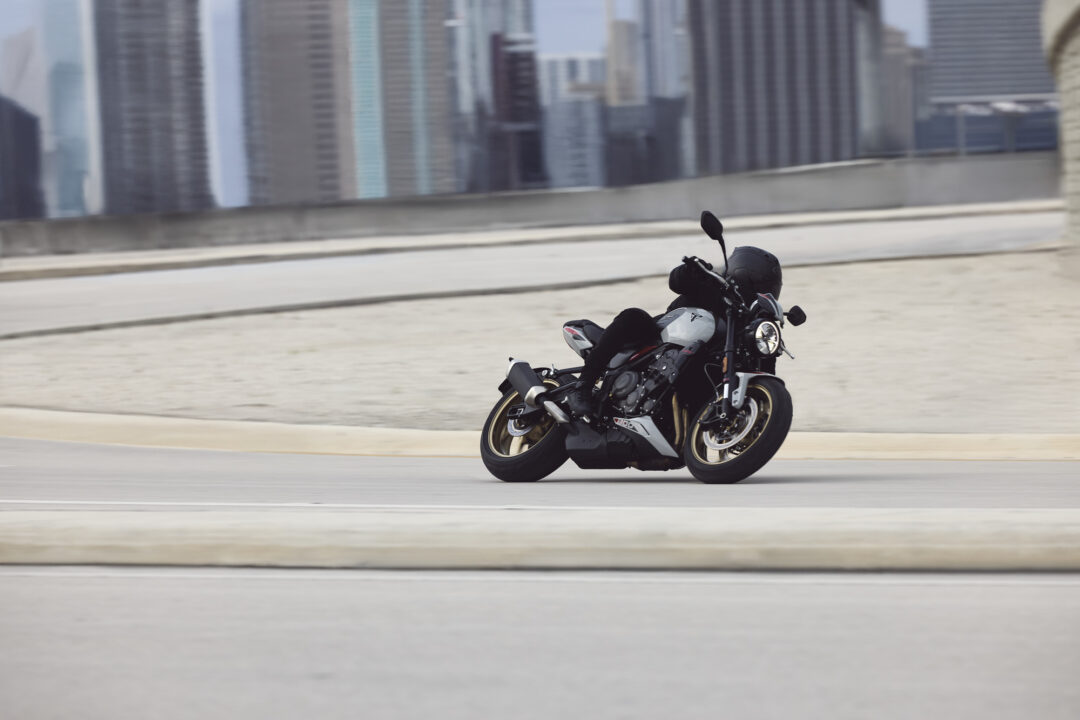 2026 Triumph Trident 800 action on a road, cornering hard