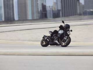 2026 Triumph Trident 800 action on a road, cornering hard