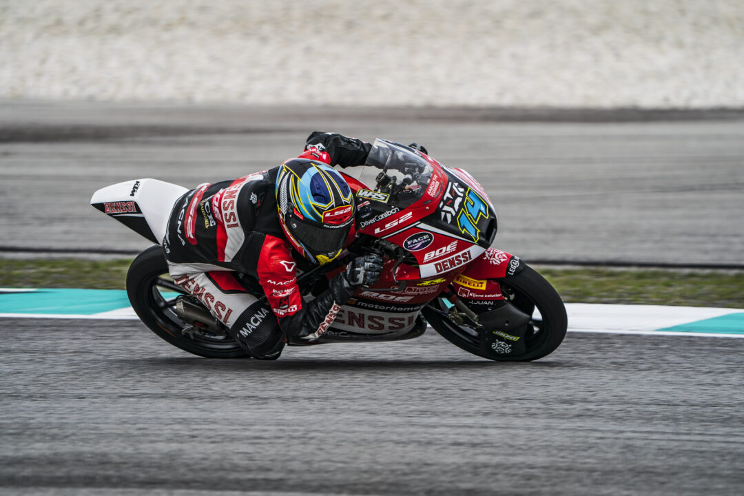 Cormac Buchanan leans into a corner on his Denssi BOE Motorsports Moto3 bike during the Malaysian Grand Prix at Sepang International Circuit. The Southland rider is wearing his blue and red race leathers under the blazing tropical heat.