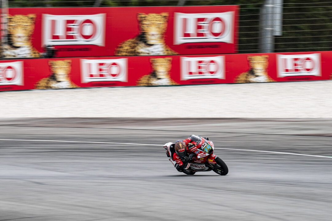 Cormac Buchanan leans into a corner on his Denssi BOE Motorsports Moto3 bike during the Malaysian Grand Prix at Sepang International Circuit. The Southland rider is wearing his blue and red race leathers under the blazing tropical heat.