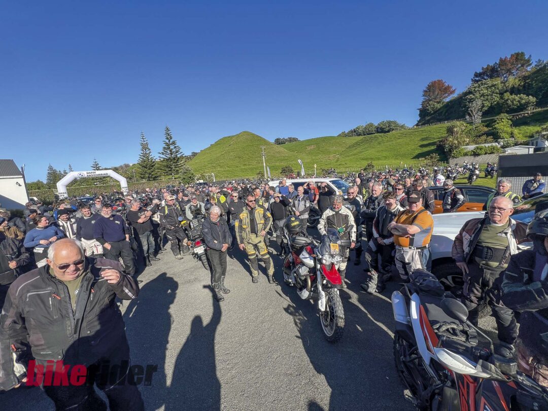 Mixed adventure riders at Kai Iwi Beach Holiday Park during BMW GS Rallye waiting for rider briefing
