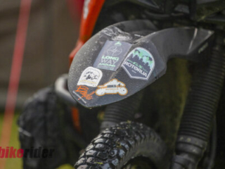Mixed adventure motorcycles parked at Kai Iwi Beach Holiday Park during BMW GS Rallye, BOYD motorcycle sticker
