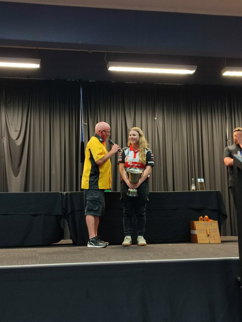 Harriet Grace becoming the first woman ever to win a race on two wheels at the Whanganui Street Race. Getting award from Neil Ritchie