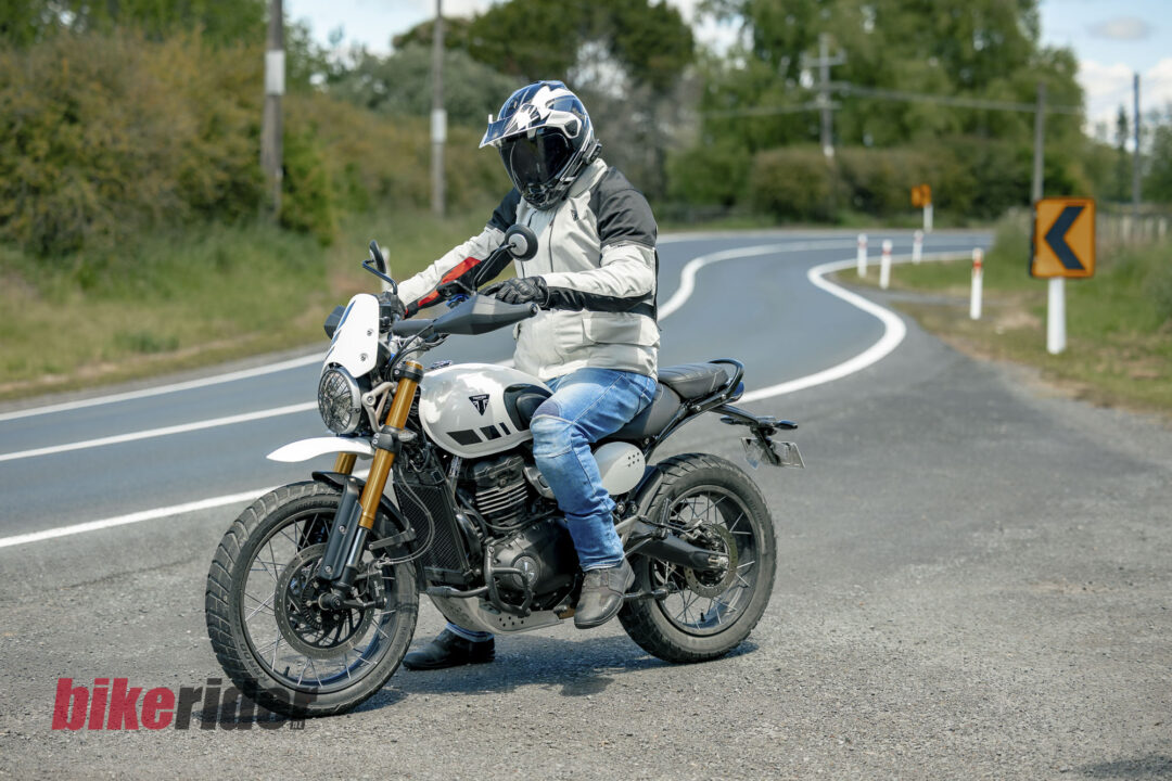 Triumph Scrambler 400XC parked next to winding road