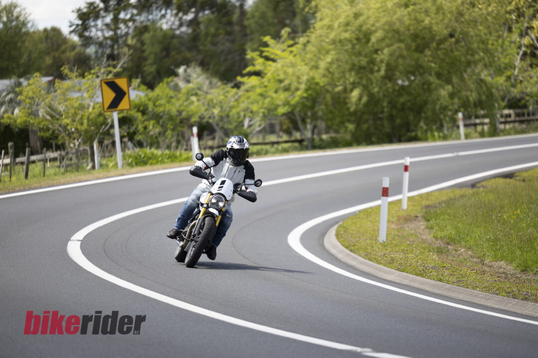 Triumph Scrambler 400XC being ridden on a winding road during road test