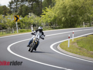 Triumph Scrambler 400XC being ridden on a winding road during road test