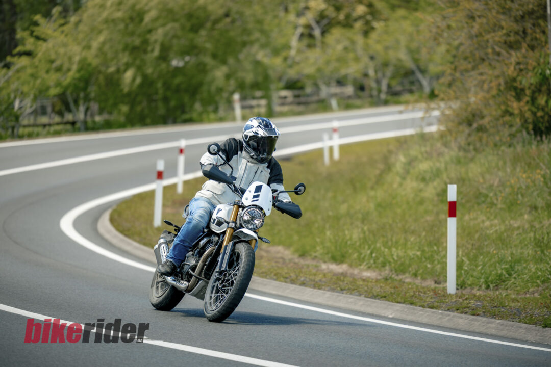 Triumph Scrambler 400XC being ridden on a winding road during road test