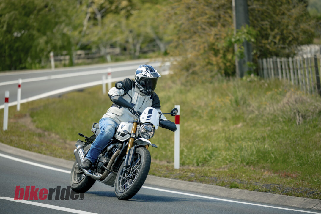 Triumph Scrambler 400XC being ridden on a winding road during road test