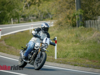 Triumph Scrambler 400XC being ridden on a winding road during road test