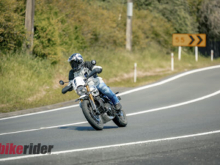 Triumph Scrambler 400XC being ridden on a winding road during road test