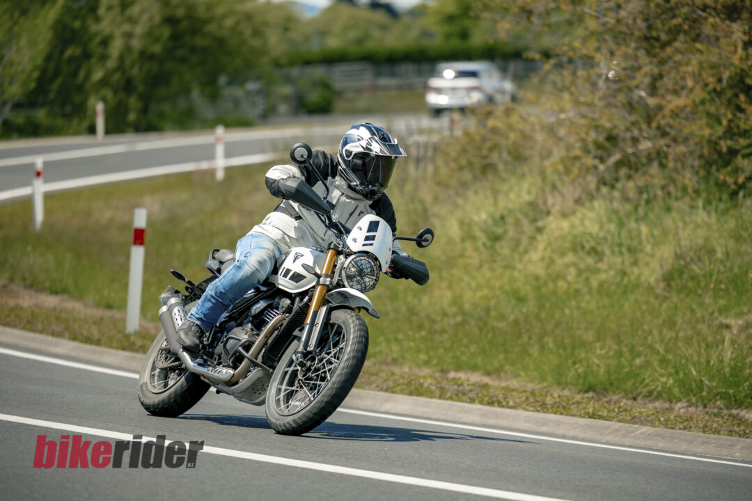 Triumph Scrambler 400XC being ridden on a winding road during road test
