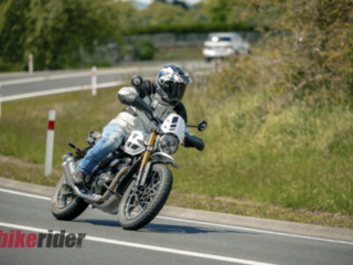 Triumph Scrambler 400XC being ridden on a winding road during road test