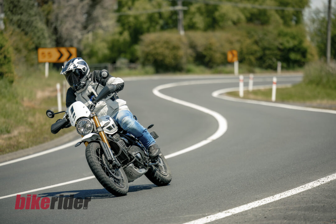 Triumph Scrambler 400XC being ridden on a winding road during road test