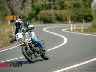 Triumph Scrambler 400XC being ridden on a winding road during road test