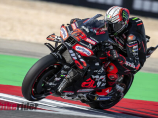MotoGP Rd21 Autodromo International Algarve Sun Moto GP Race-Marco Bezzecchi wheelie Aprilia MotoGP bike action track
