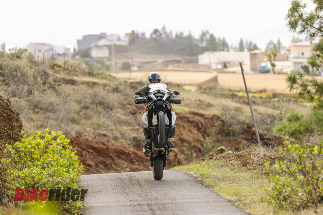 KTM 1390 Super Adventure EVO S review action on the road cornering wheelie without clutch
