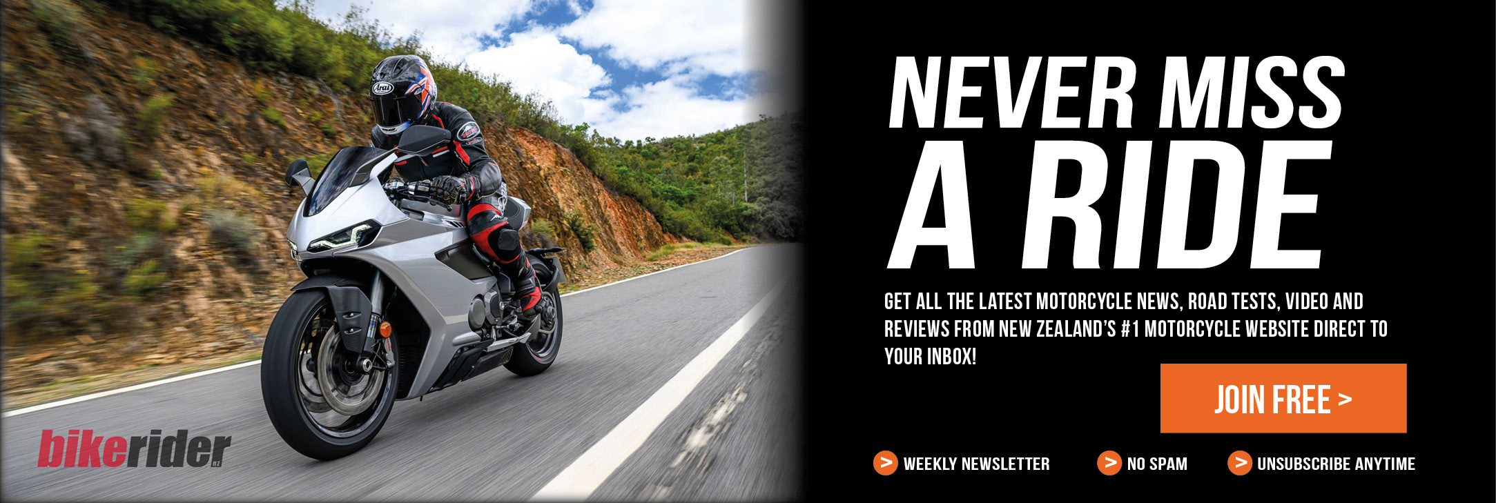 Motorcycle rider on a silver sport bike on a winding road, with a bold 'Never Miss A Ride' ad on the right and a 'Join Free' button.