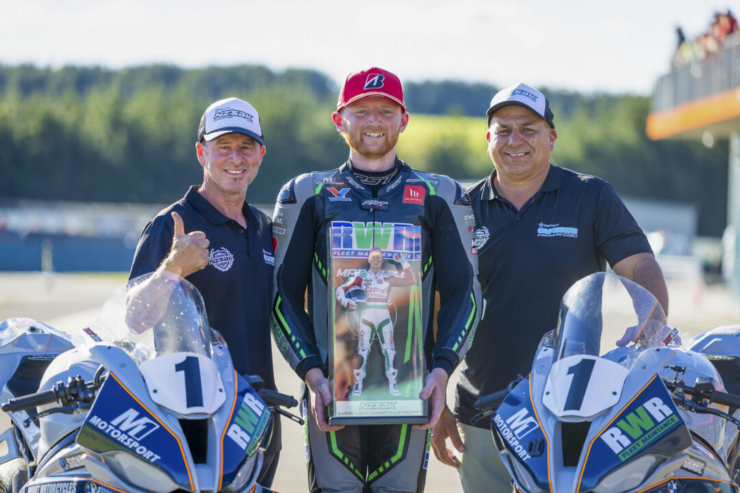 2026 Superbike Champion Rogan Chandler wins the Aaron Slight Championship Trophy, flanked here by Aaron Slight (left) and NZSBK series promoter Mike Marsden at Motomania Round 4 of the 2026 New Zealand Super Bike Championships held at Taupo Motorsport Park, Taupo, Waikato, New Zealand, March 14-15, 2026. Photo: MNZ/Derek Morrison