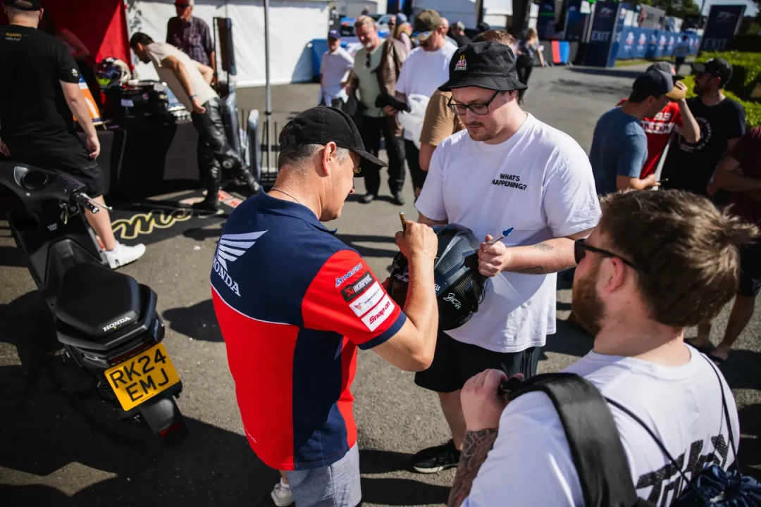 Fan favourite John McGuiness was in fine form signing autographs after his 130mph lap