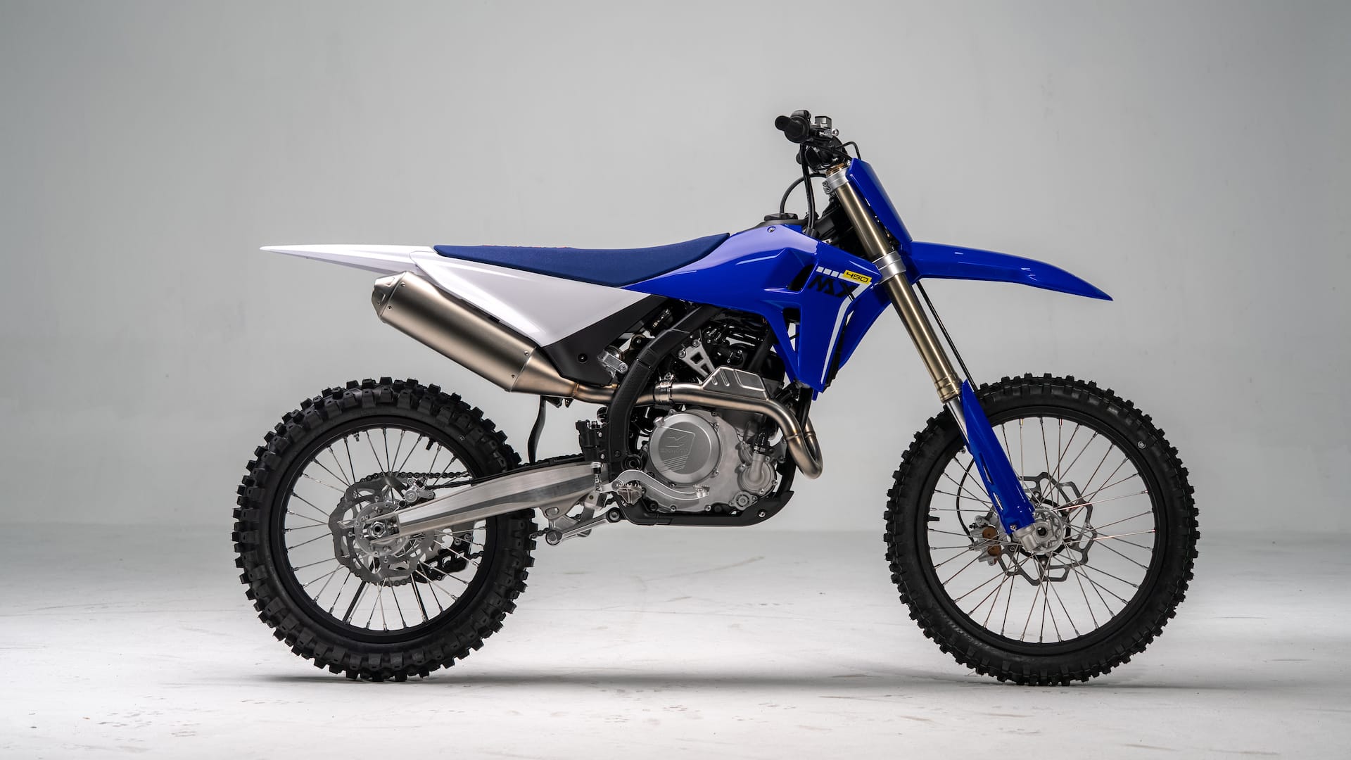 Blue ZXMOTO MX450 motocross motorcycle in side profile