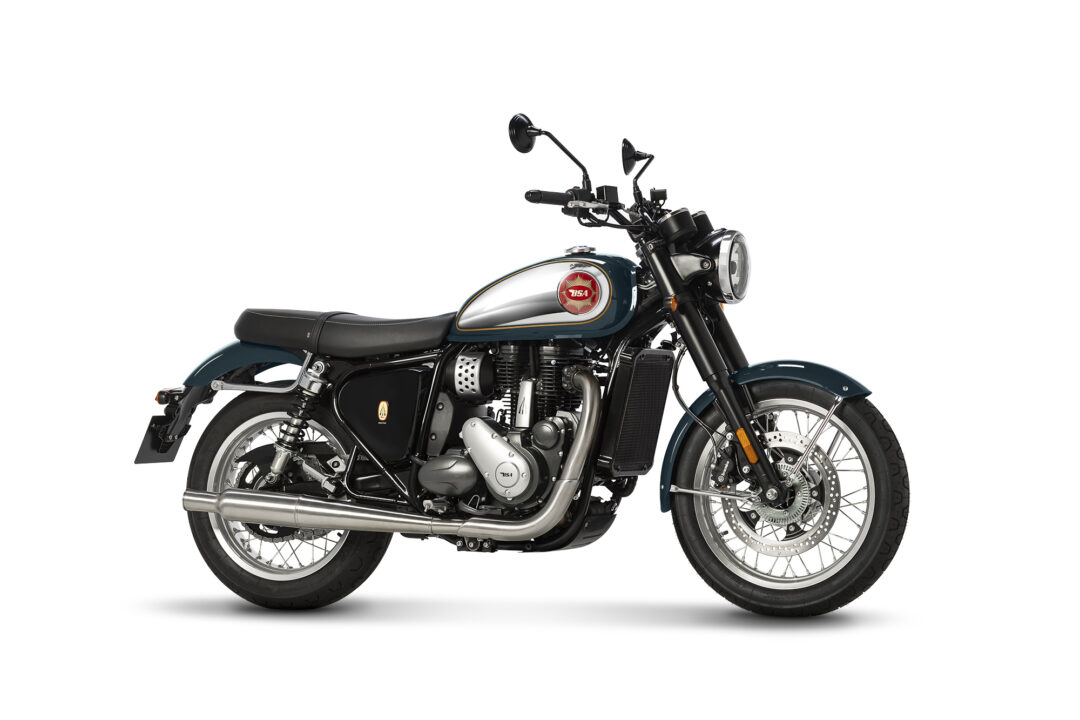 Left-side view of a vintage teal and chrome motorcycle with a red BSA emblem on the fuel tank.