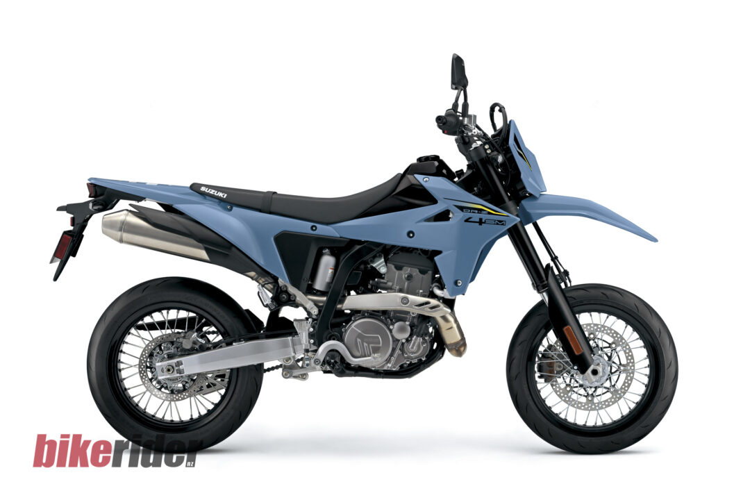 Blue Suzuki DR‑Z 400SM motorcycle shown in a left-side profile against a white background, with a partial bike rider.nz logo at the bottom left.