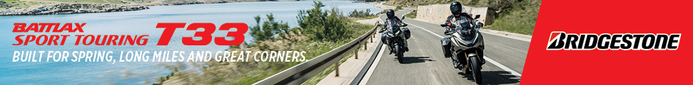 Bridgestone Battlax T33 sport touring tires banner with two motorcyclists on a coastal highway and the slogan: Built for spring, long miles and great corners.