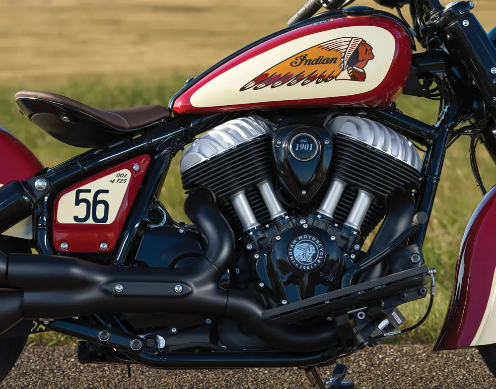 Close-up of a red-and-cream Indian Motorcycle tank and V-twin engine with racing number 56.