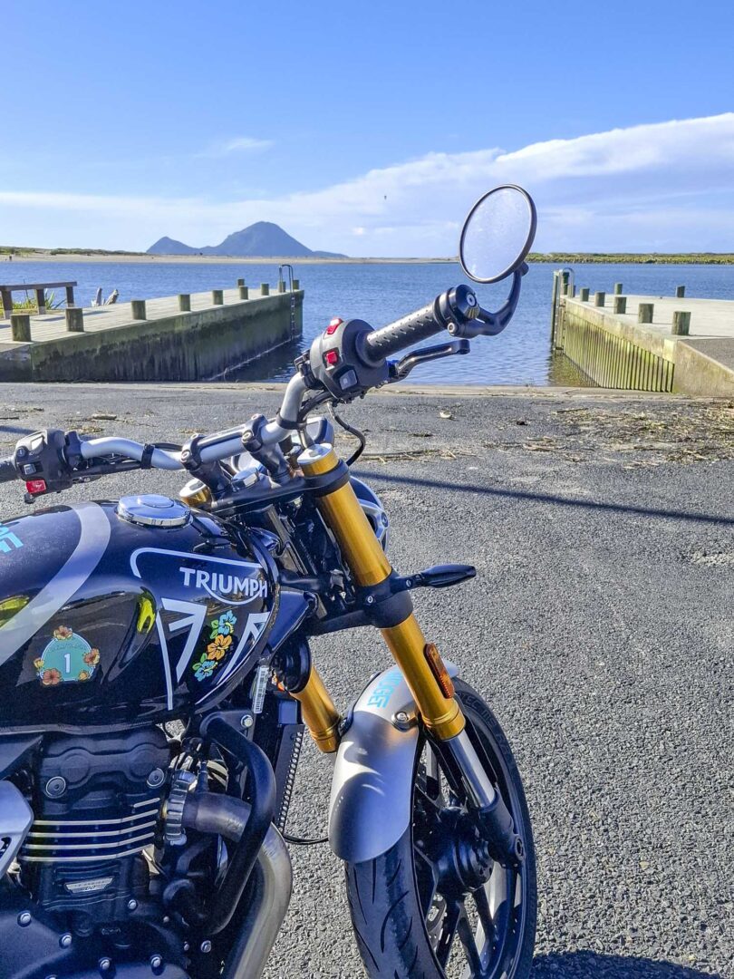 Triumph 400X NZ parked by ocean