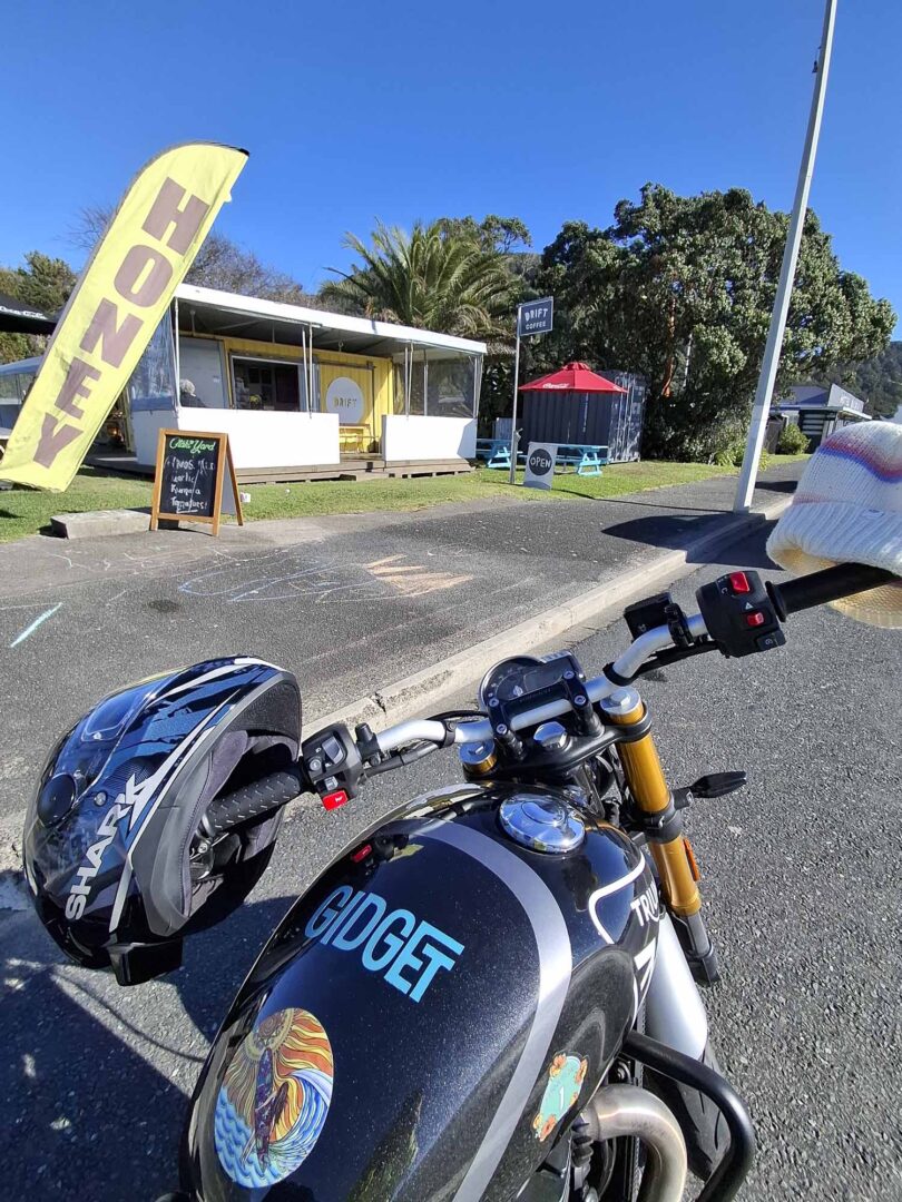 Triumph 400X NZ parked outside cafe