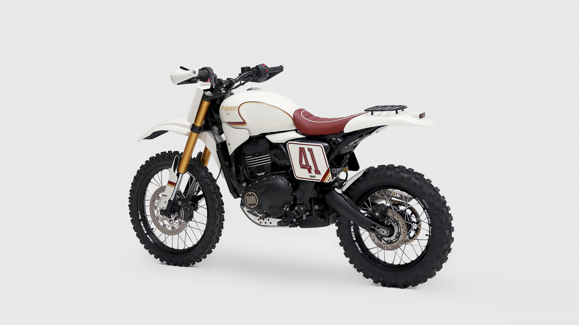 Rear three-quarter view of Tamarit’s Scrambler 400 XC with red seat and knobbly tyres