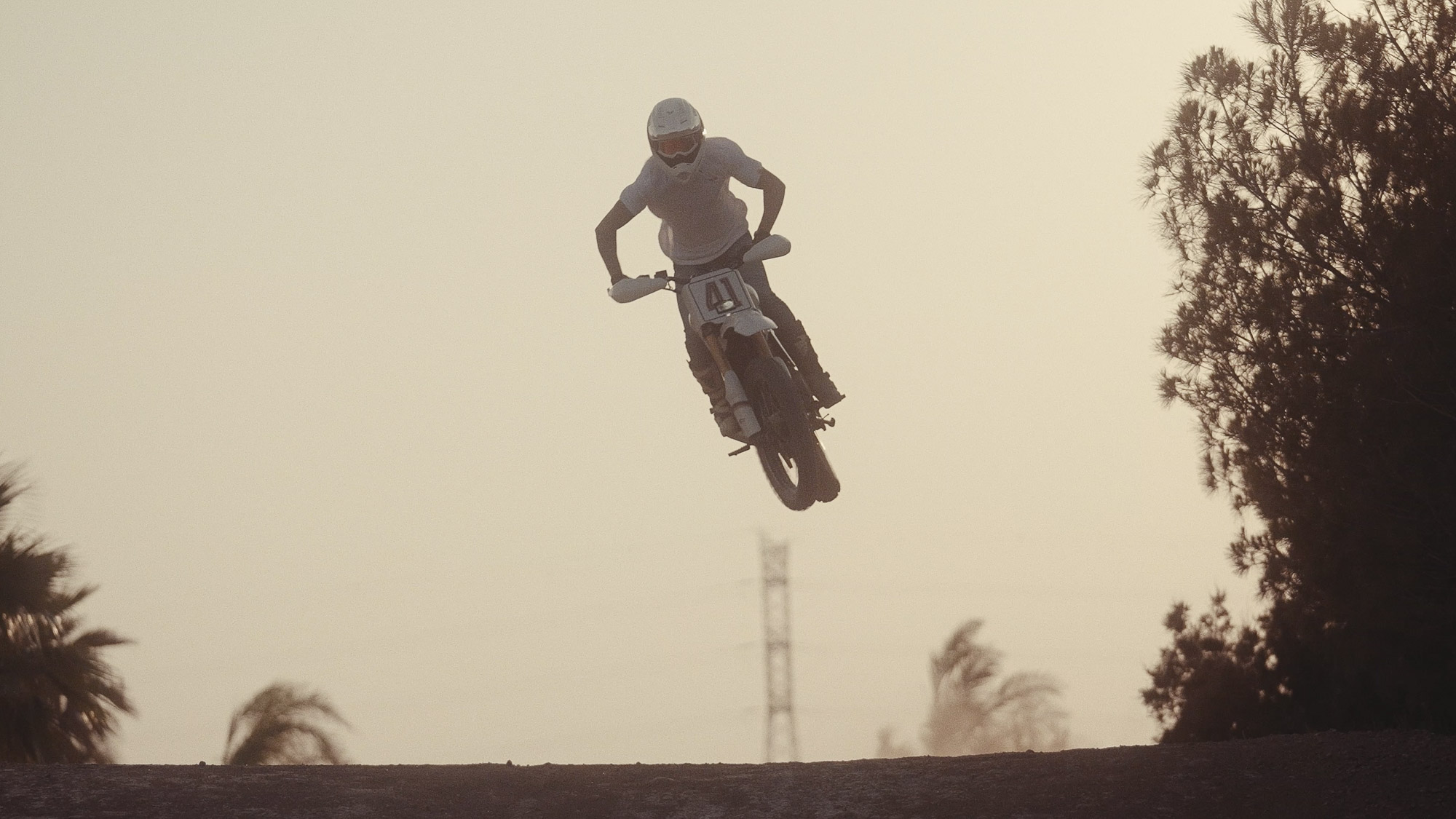 Tamarit’s number 41 Scrambler 400 XC airborne over a dirt rise