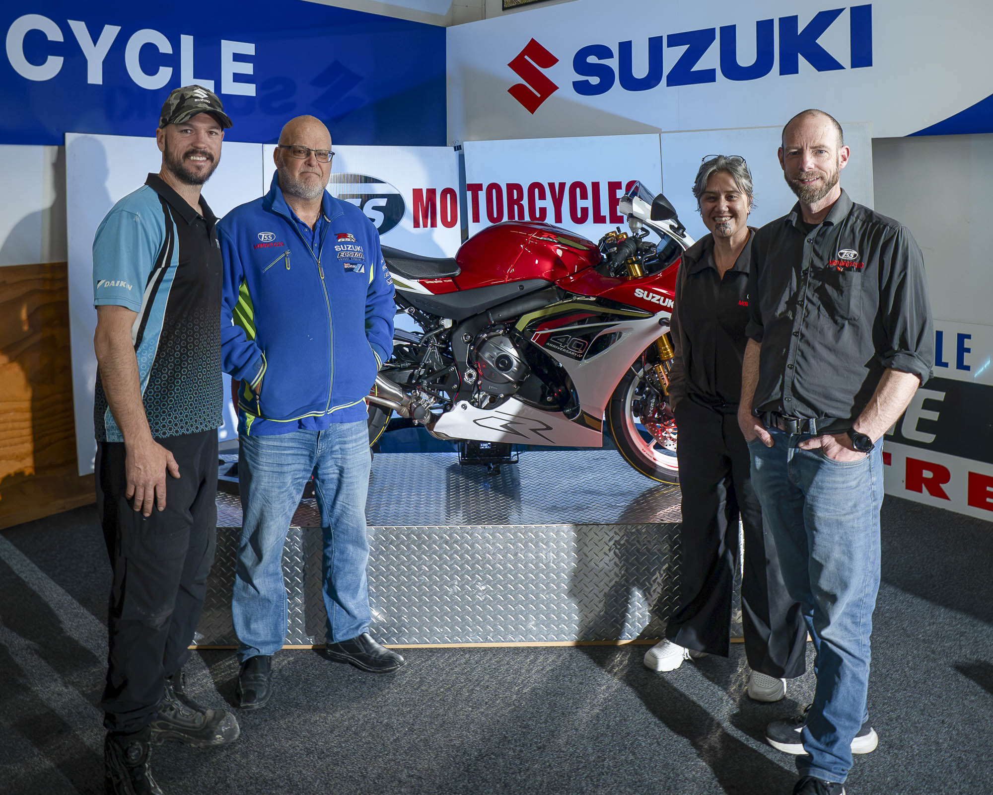 Launch attendees with the red Suzuki GSX-R1000R at TSS Motorcycles