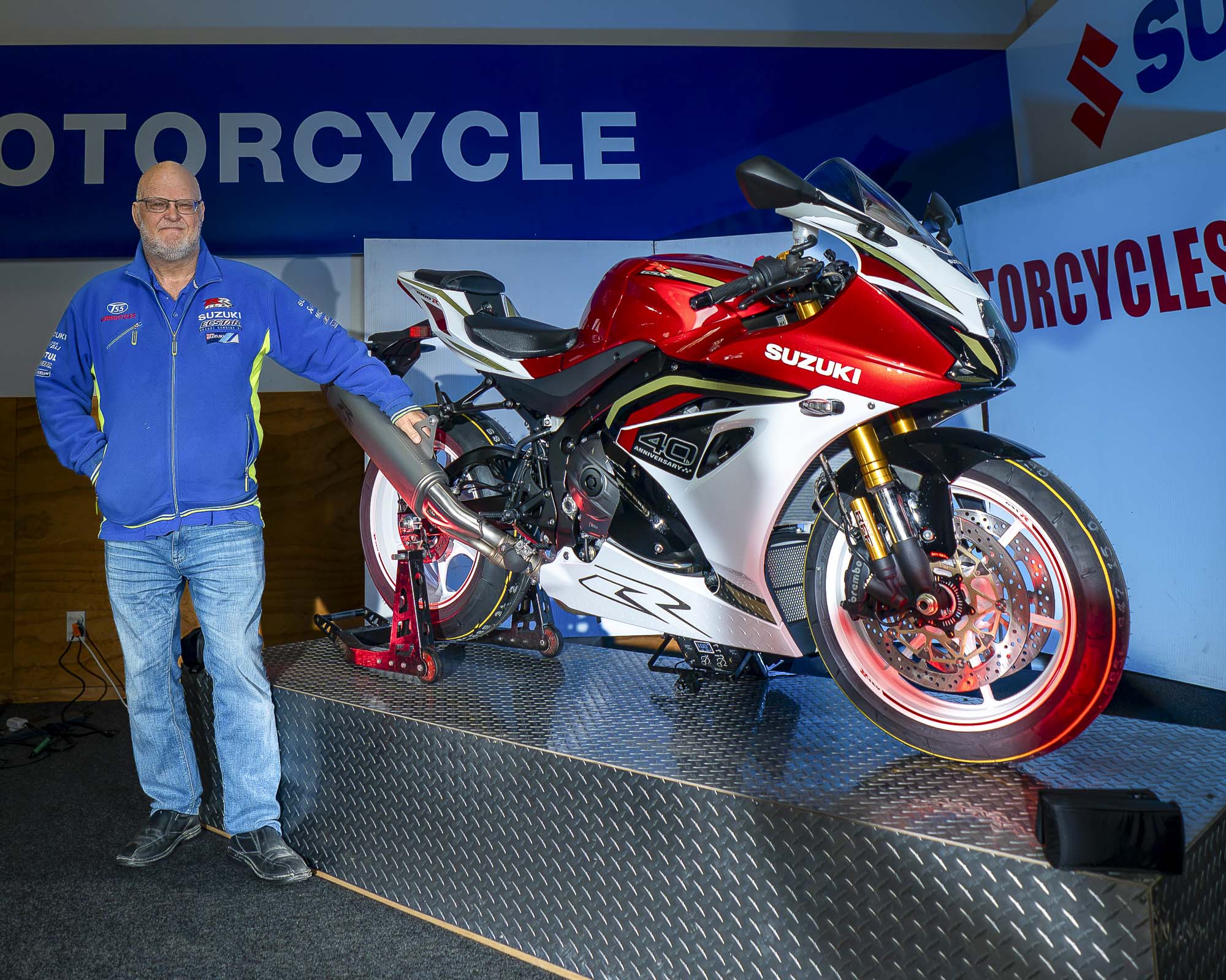 A launch attendee beside the red Suzuki GSX-R1000R on display at TSS Motorcycles
