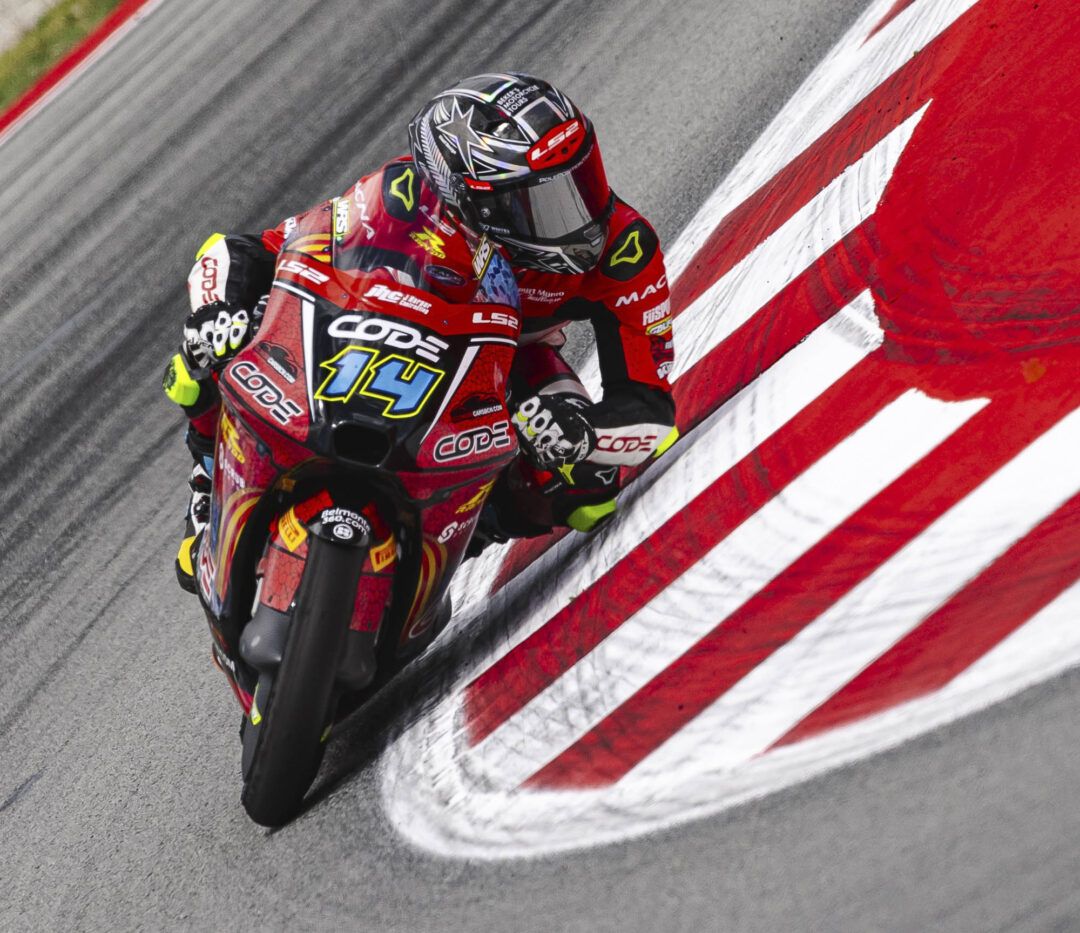 Cormac Buchanan racing his number 14 Moto3 motorcycle at Barcelona