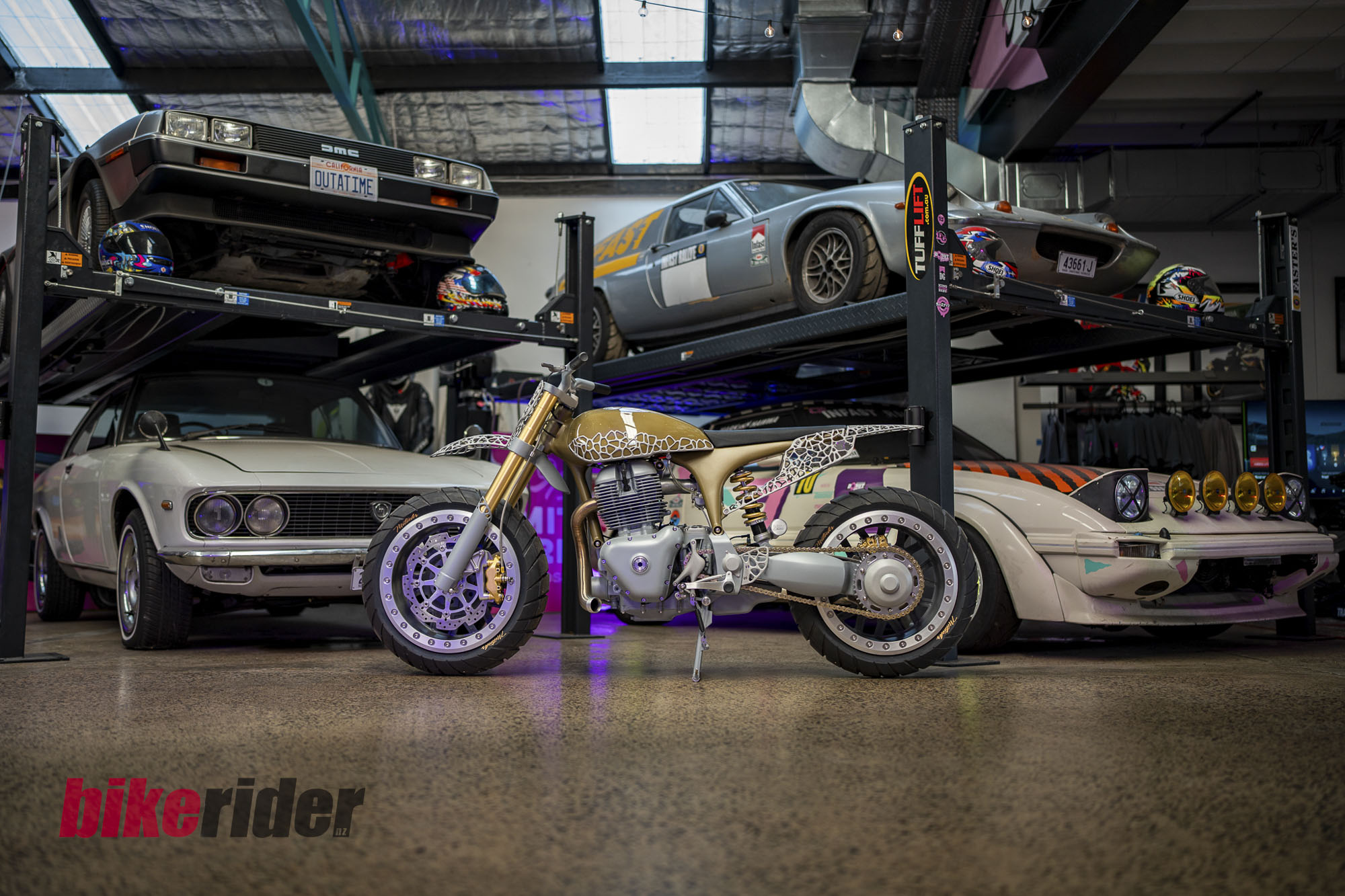Project MEGA beneath a car in the Black Cycles workshop
