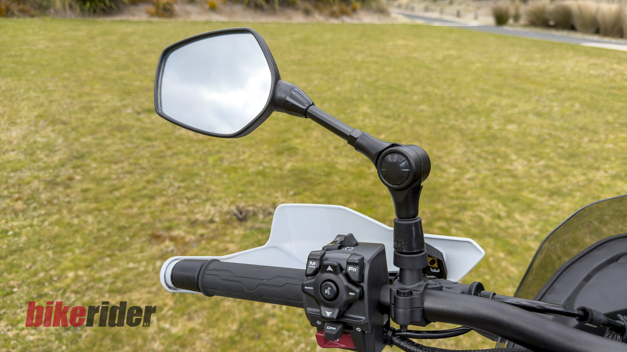 CFMOTO 1000MT-X adventure bike left handlebar controls, handguard and folding mirror