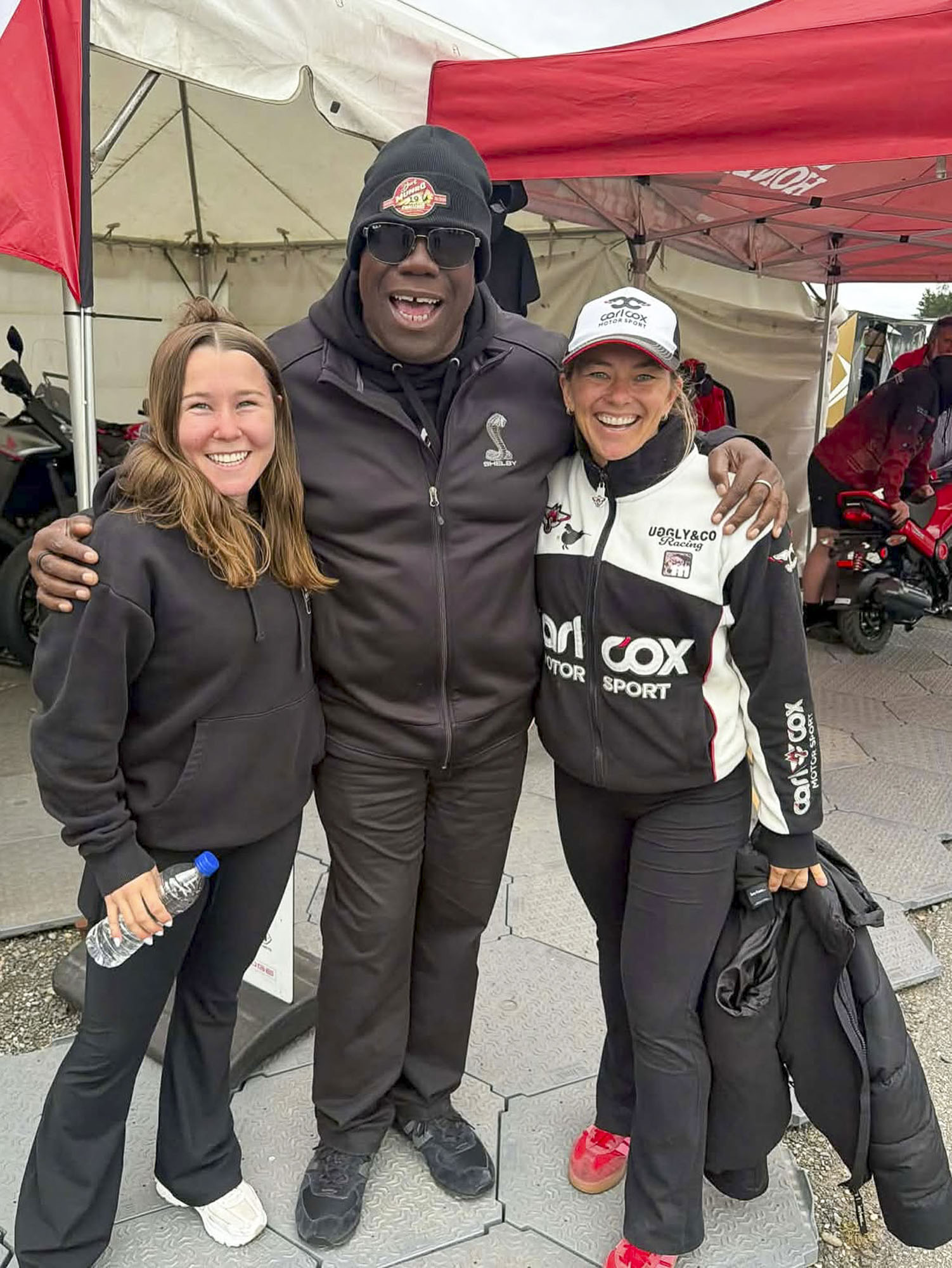 Avalon Lewis with Carl Cox and a team member in the paddock