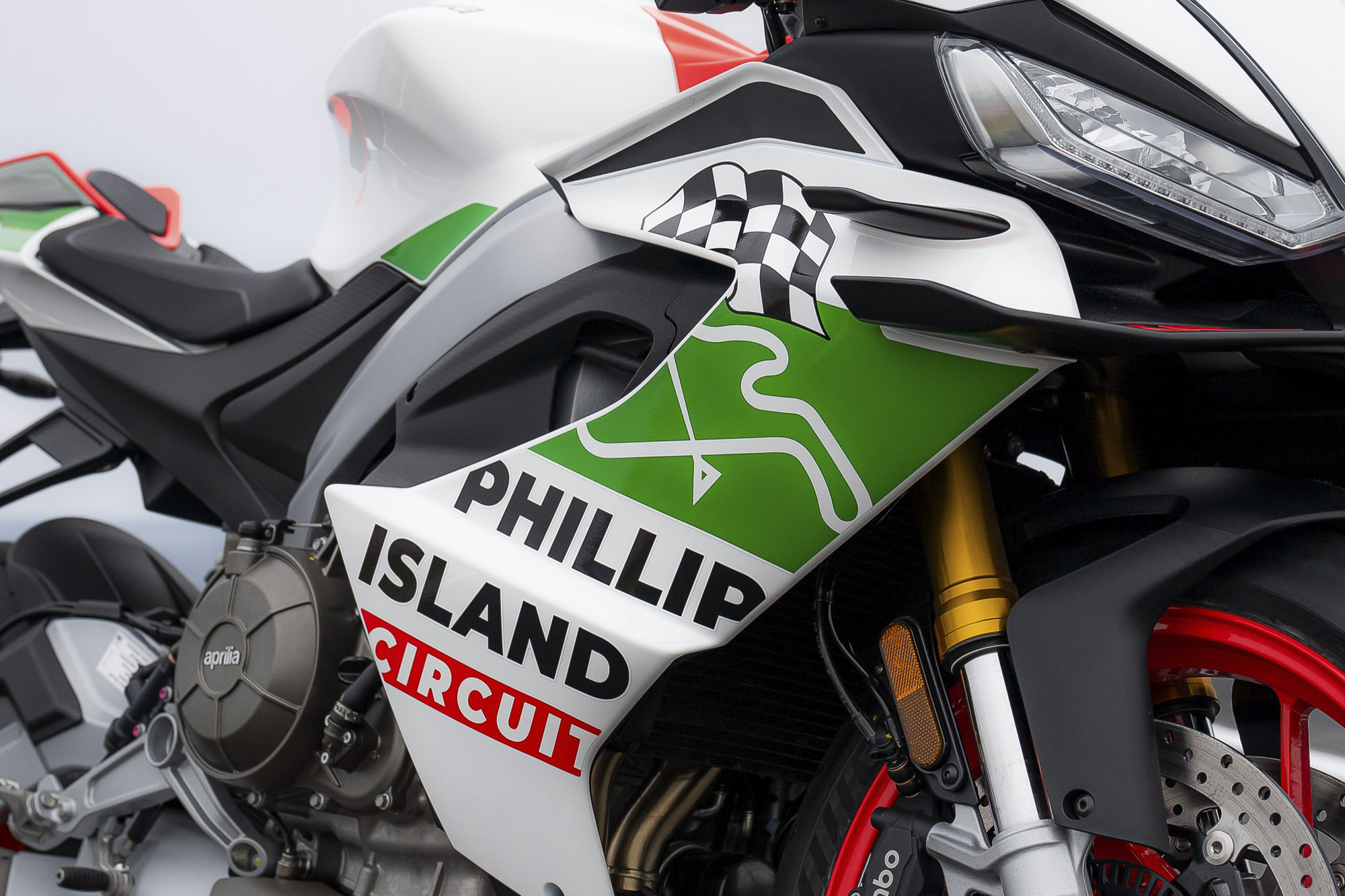 Aprilia RS 660 Phillip Island Tribute fairing with circuit outline, chequered flag and green accents.
