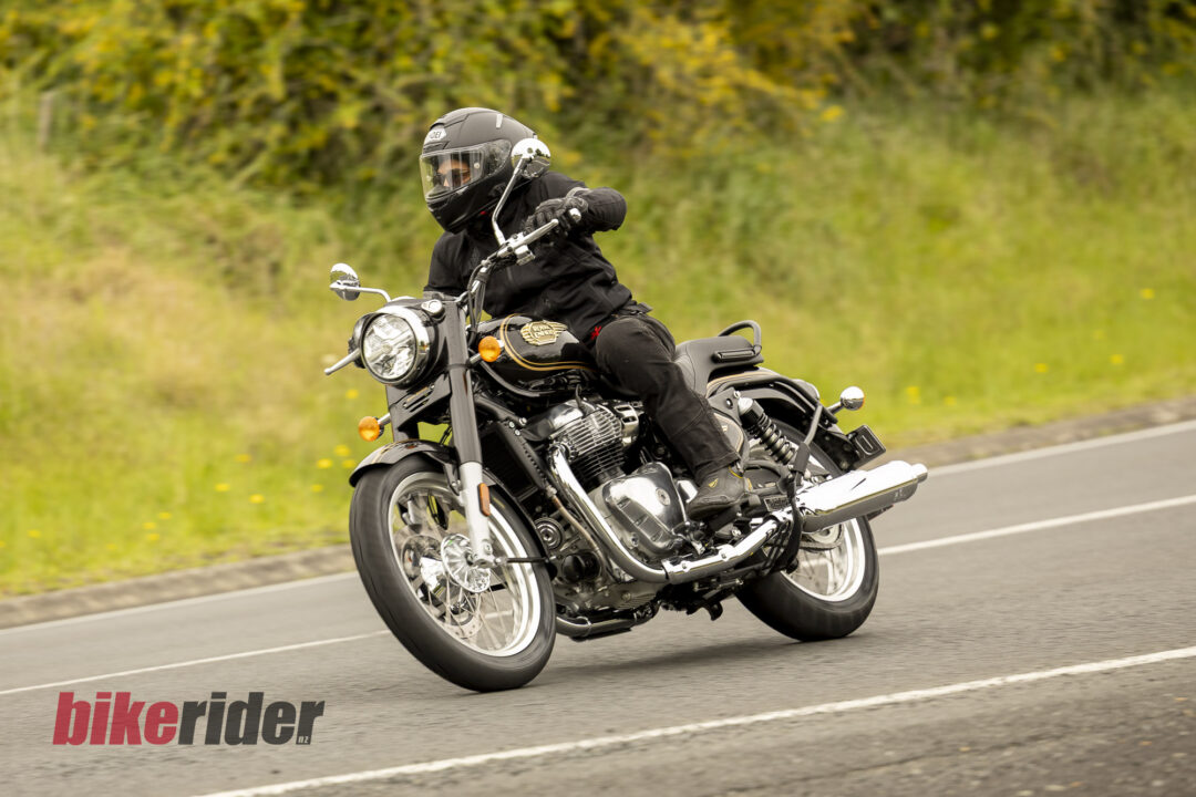 Royal Enfield Bullet 650 in Cannon Black: rider front three-quarter road action