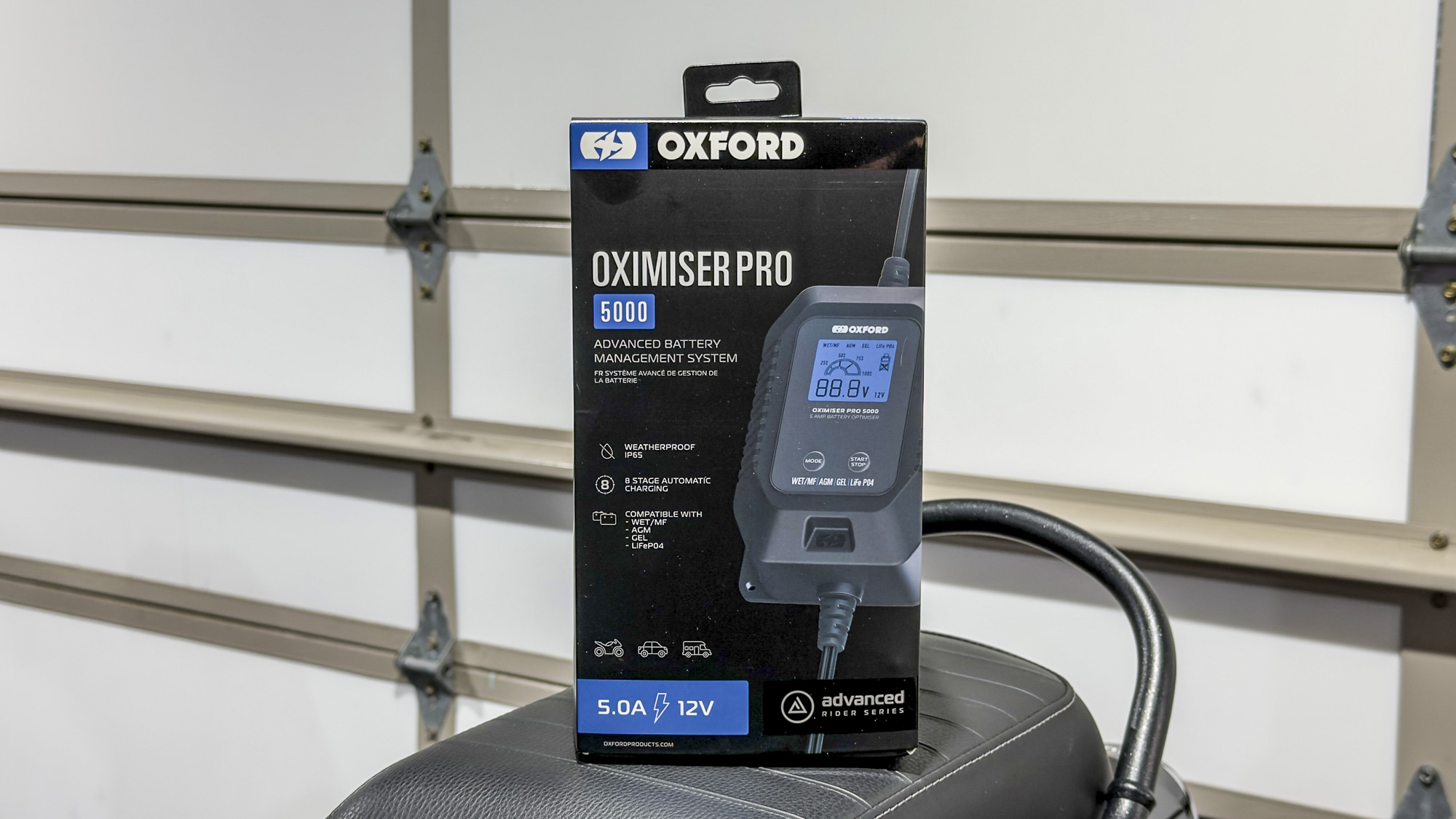 Oxford Oximiser Pro 5000 box on a motorcycle seat in the BRM garage