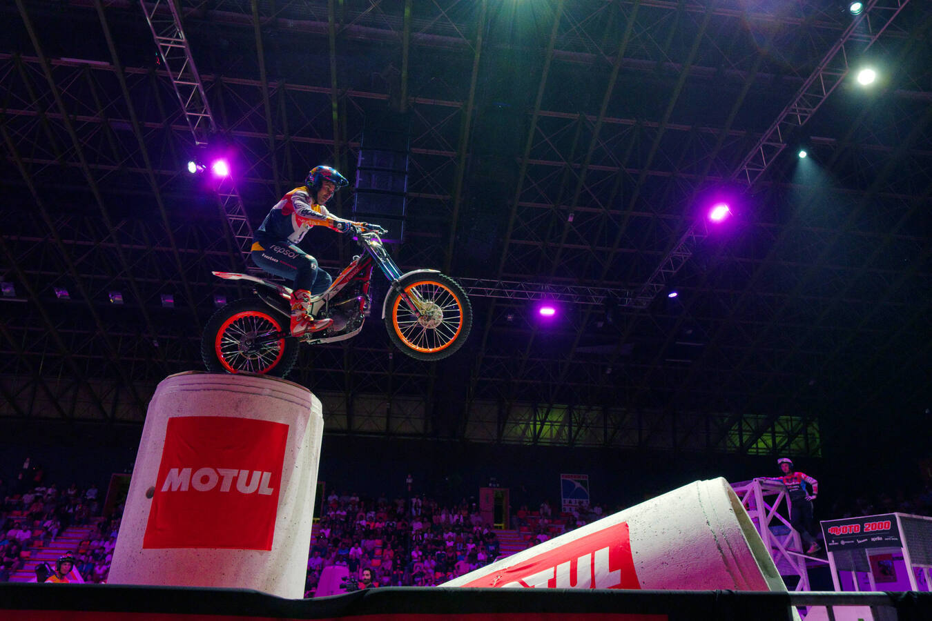Toni Bou balancing his Montesa on a high obstacle during indoor trials competition