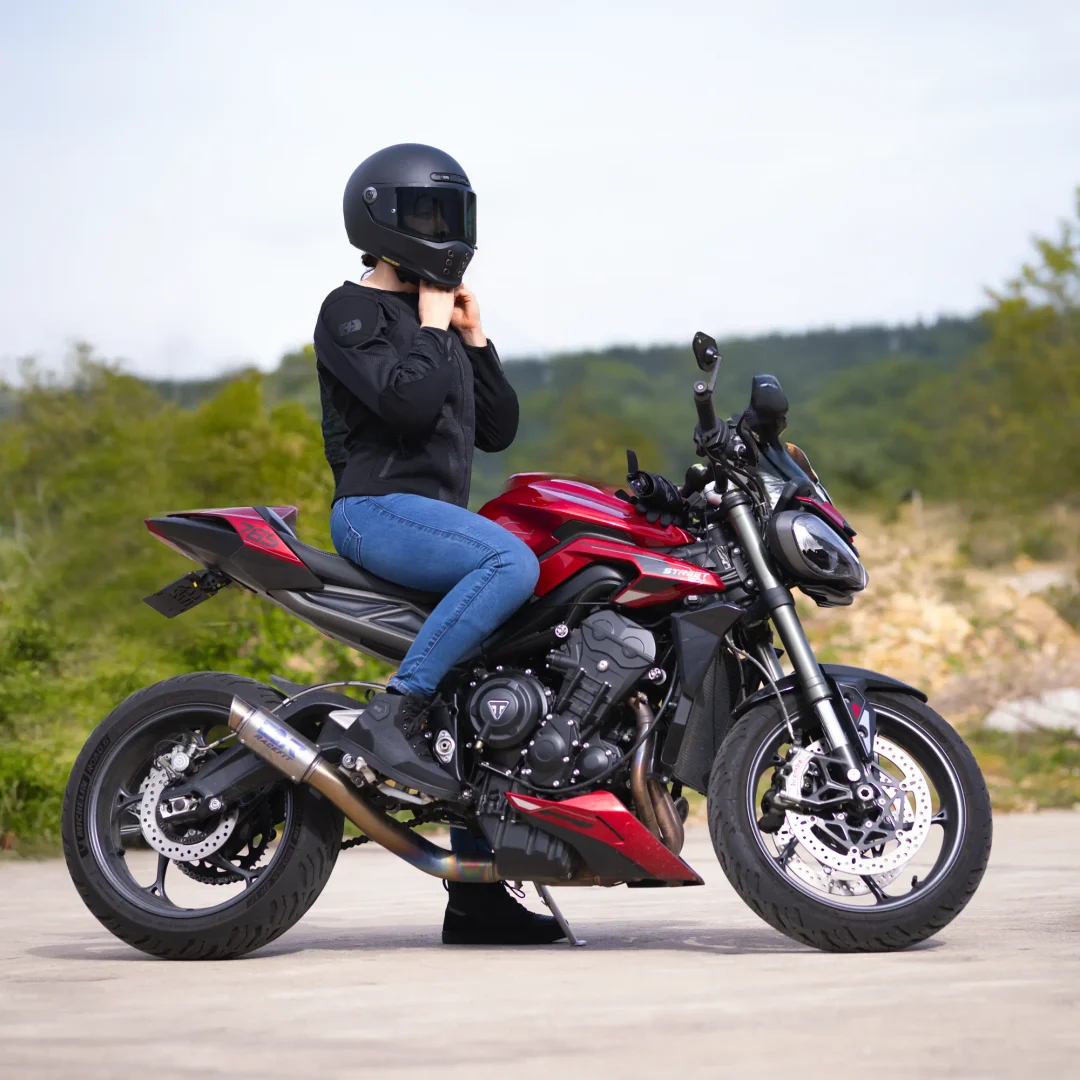 Rider wearing Oxford women’s jeans on a red motorcycle