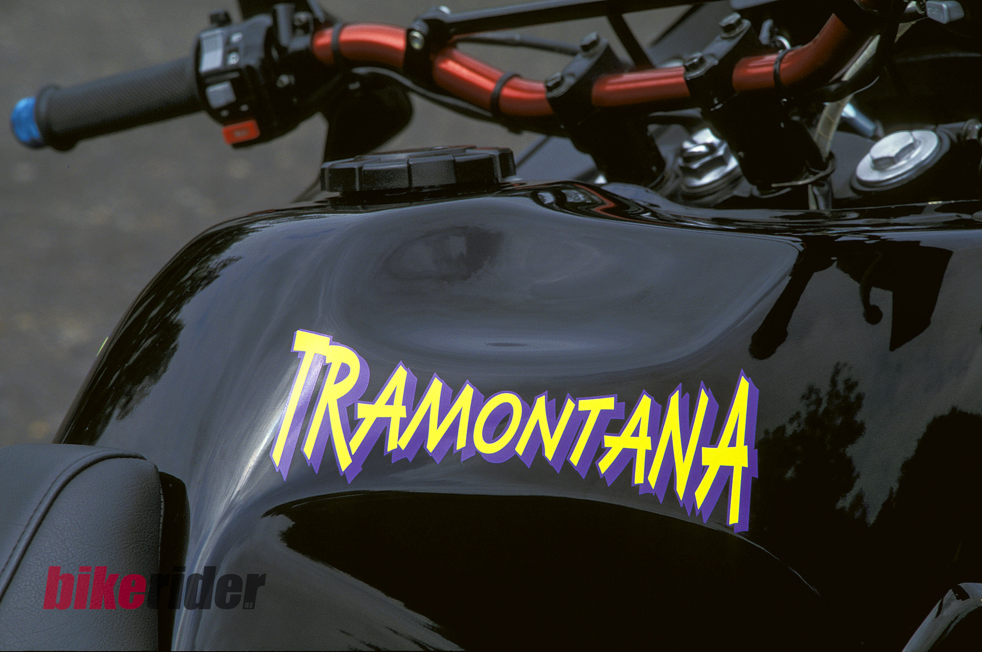 Tramontana branding on the fuel tank, with the boost gauge visible ahead.